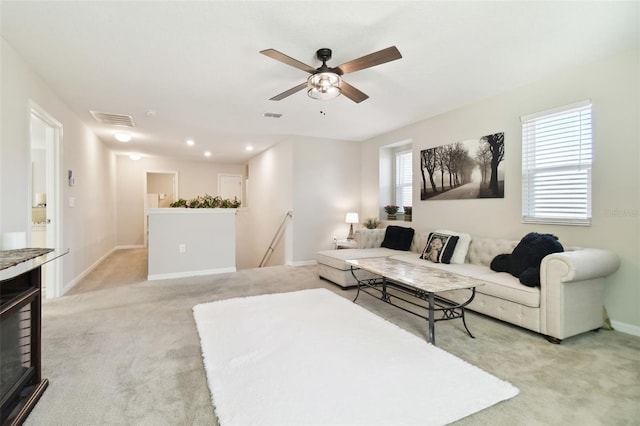 carpeted living room featuring ceiling fan