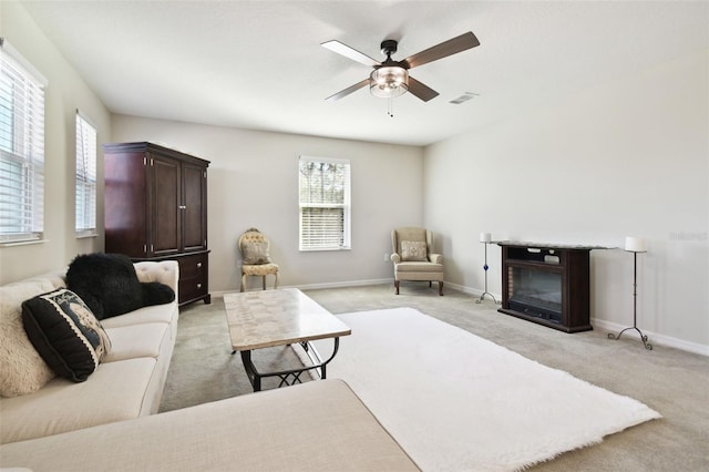 carpeted living room featuring ceiling fan