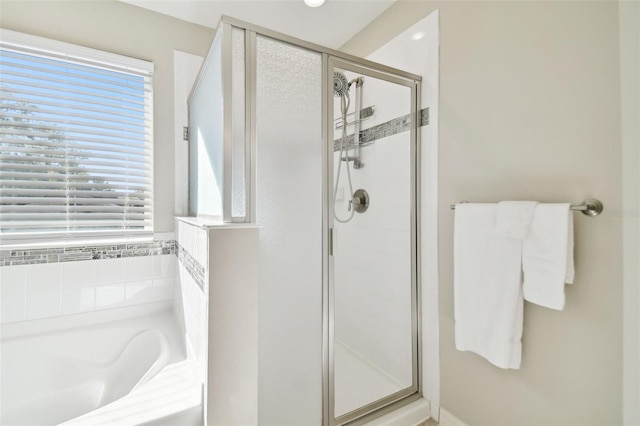 bathroom featuring independent shower and bath