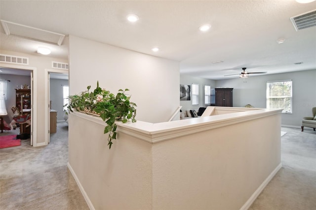 interior space with light colored carpet and ceiling fan