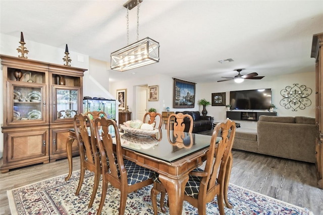 dining room with hardwood / wood-style floors and ceiling fan