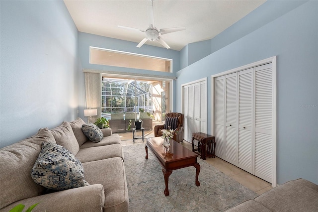 living room with light tile patterned floors and ceiling fan