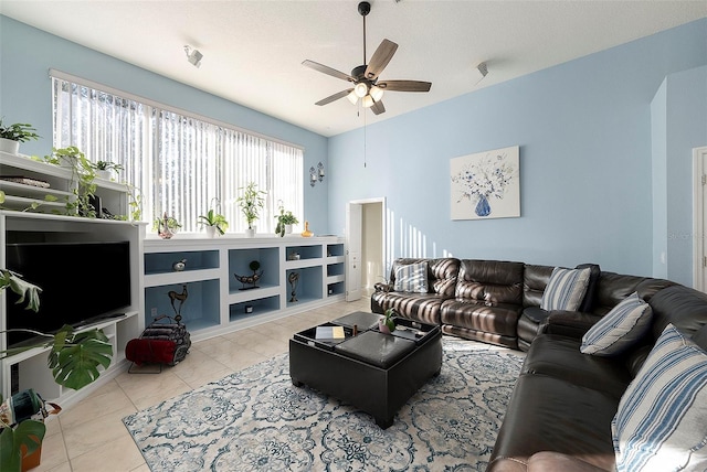 tiled living room featuring ceiling fan and a textured ceiling