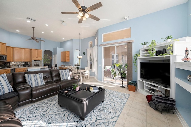 living room with light tile patterned floors and ceiling fan