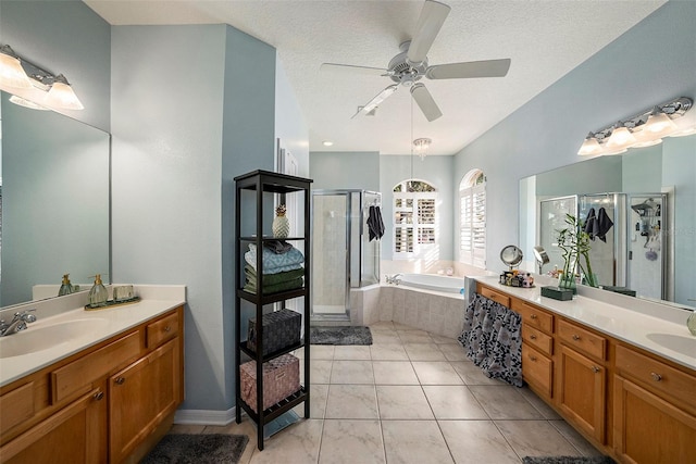 bathroom featuring ceiling fan, vanity, a textured ceiling, and independent shower and bath