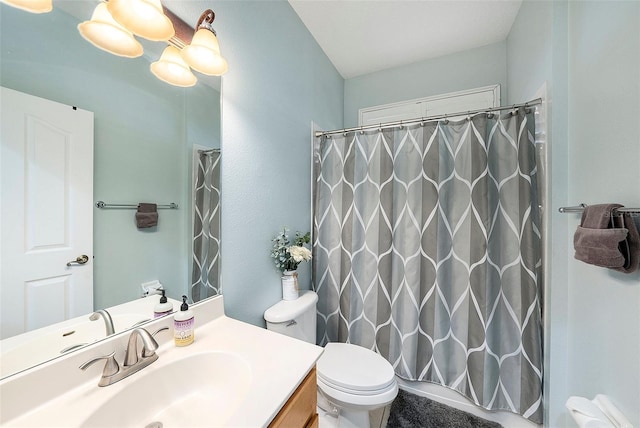 bathroom with vanity, curtained shower, and toilet