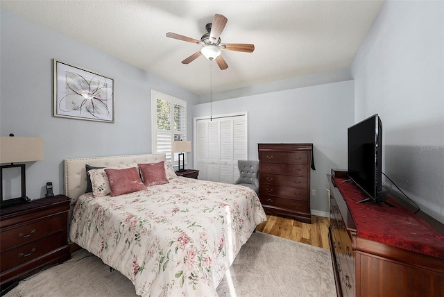 bedroom featuring a closet, ceiling fan, and light hardwood / wood-style floors