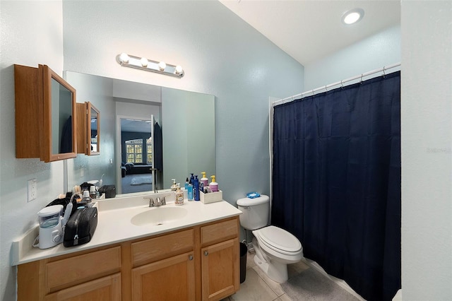 bathroom featuring toilet, vanity, and tile patterned floors