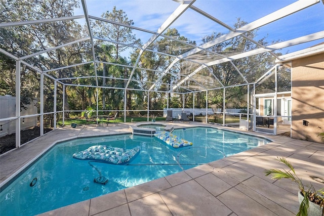 view of swimming pool featuring an in ground hot tub, a patio, and glass enclosure