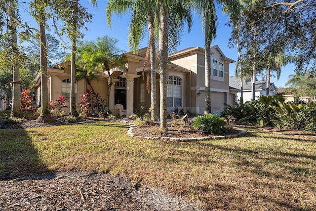 view of front of property with a front yard and a garage