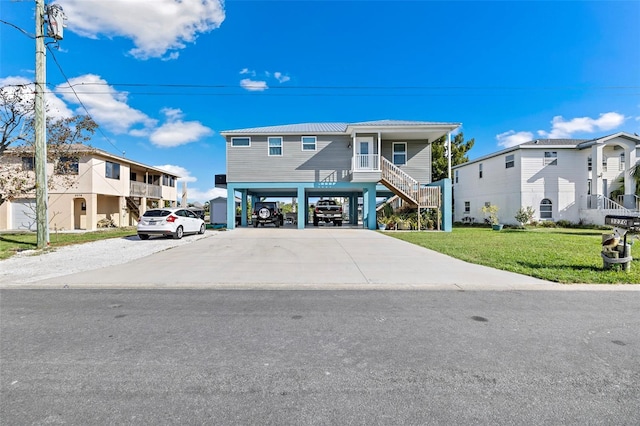 view of front of house featuring a front yard, a carport, and covered porch