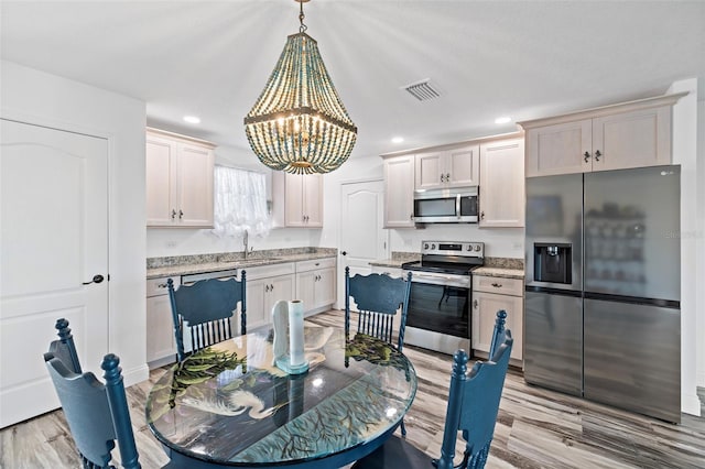 3270 Hibiscus Dr, Hernando Beach, FL 34607 - dining space with a chandelier, light wood-type flooring, and recessed lighting