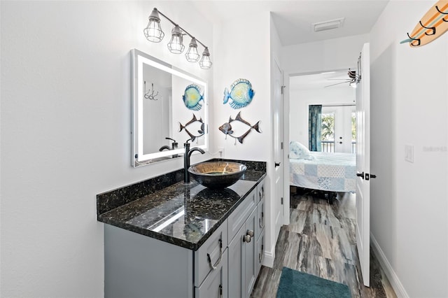 bathroom featuring hardwood / wood-style flooring, ceiling fan, and vanity