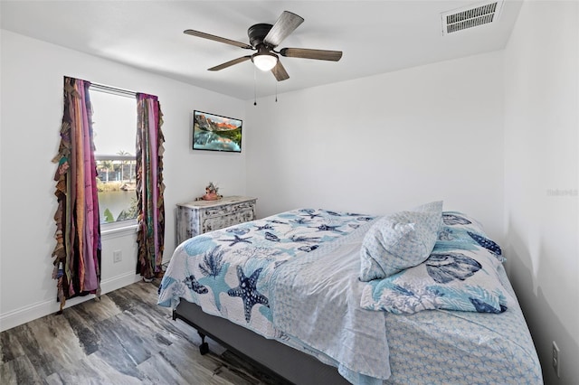 bedroom with hardwood / wood-style floors and ceiling fan