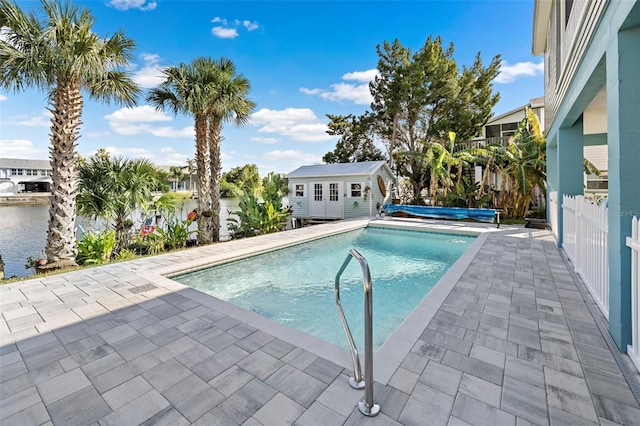 view of pool featuring a patio and an outdoor structure