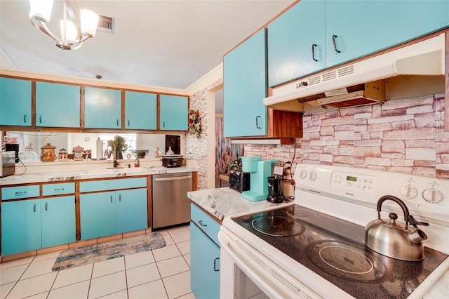 kitchen with hanging light fixtures, sink, light tile patterned floors, blue cabinetry, and appliances with stainless steel finishes