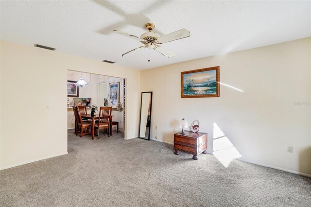 interior space with ceiling fan and carpet