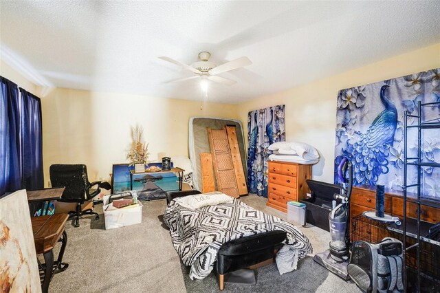 carpeted bedroom with ceiling fan and a textured ceiling