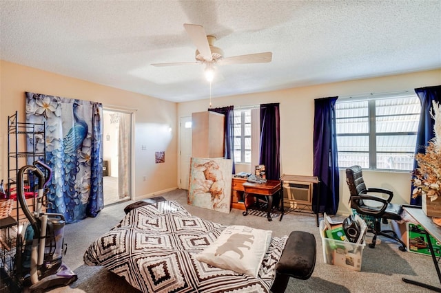 carpeted bedroom featuring ceiling fan, a textured ceiling, and multiple windows