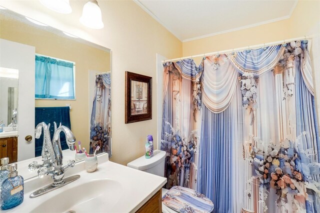 bathroom with walk in shower, toilet, vanity, and ornamental molding