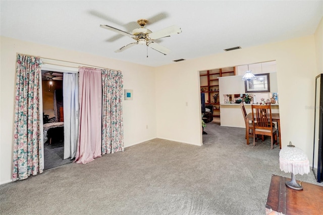 carpeted living room featuring ceiling fan