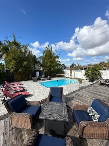 view of swimming pool featuring a deck