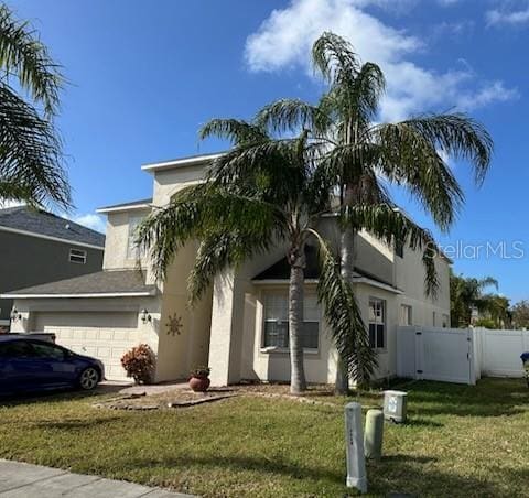 view of front of house with a front yard and a garage