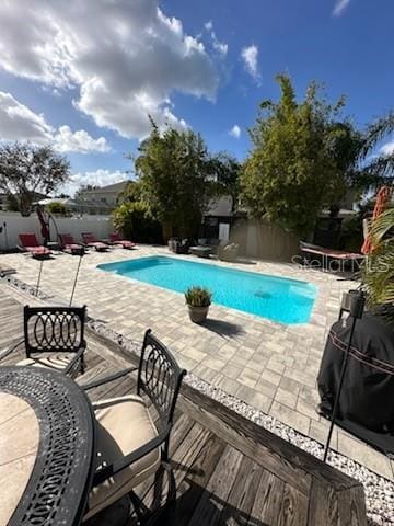 view of swimming pool with a patio and grilling area