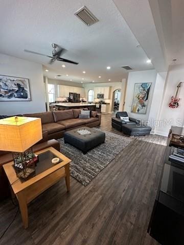 living room with ceiling fan and hardwood / wood-style floors