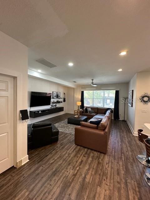 living room with dark hardwood / wood-style floors and ceiling fan