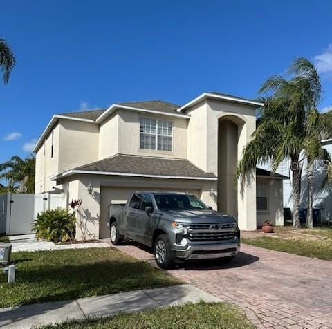 view of front of property featuring a garage and a front lawn