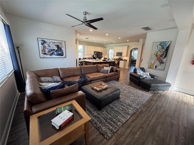 living room with hardwood / wood-style floors and ceiling fan