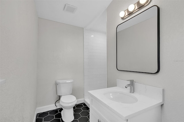 bathroom with tile patterned floors, vanity, and toilet