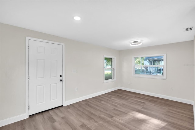 empty room with light hardwood / wood-style floors