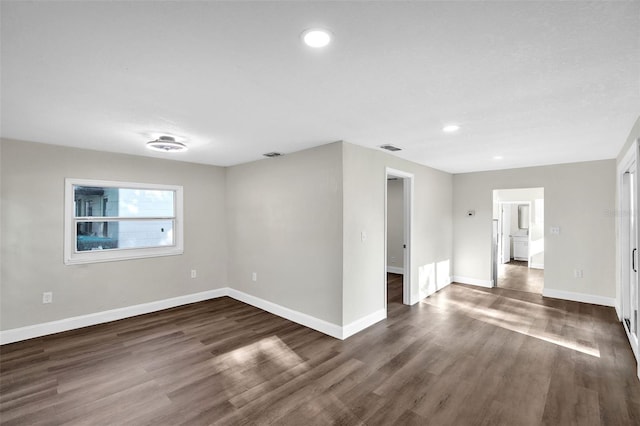 spare room featuring dark hardwood / wood-style floors