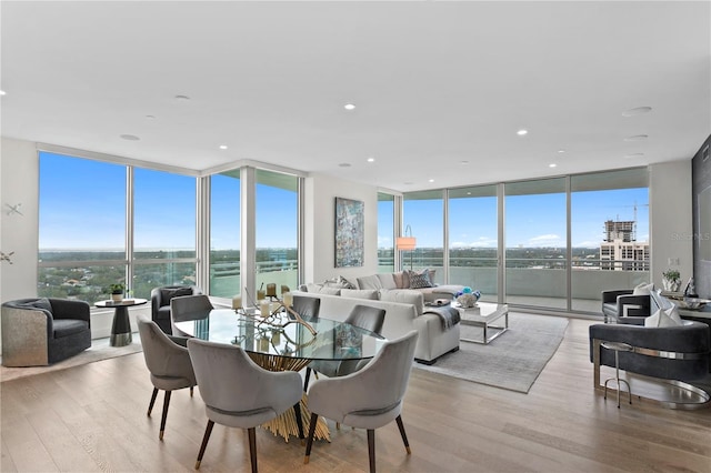 dining area featuring a wall of windows and a healthy amount of sunlight