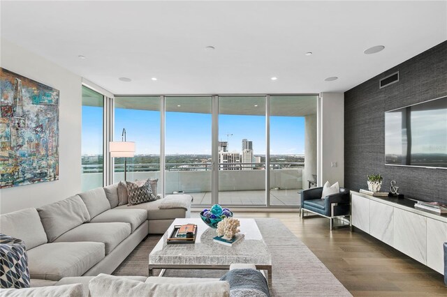 living room featuring dark hardwood / wood-style flooring and expansive windows