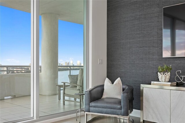 living area featuring a water view and a wealth of natural light