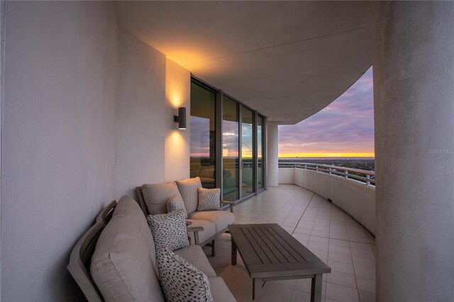 balcony at dusk featuring outdoor lounge area