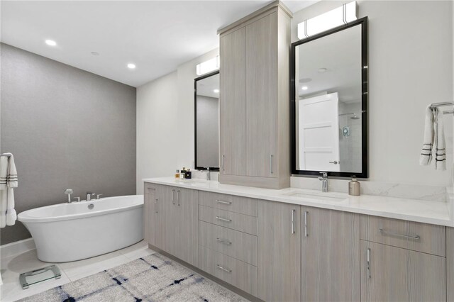 bathroom with vanity, a tub to relax in, and tile patterned floors