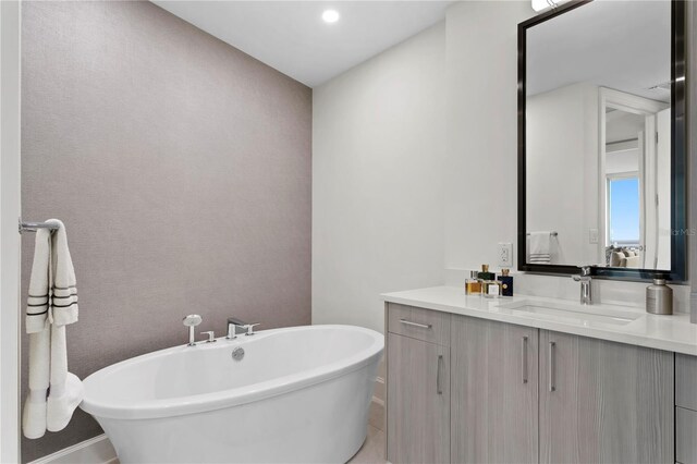 bathroom with a bathing tub and vanity