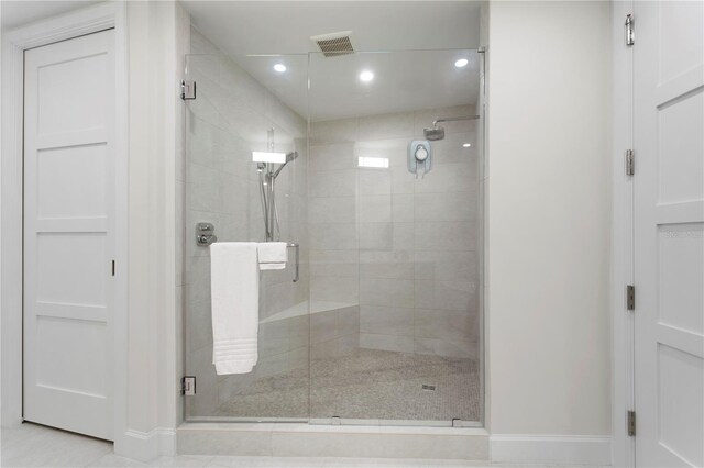 bathroom with tile patterned flooring and walk in shower