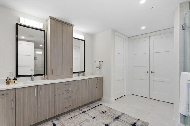 bathroom with vanity, tile patterned floors, and a shower with door