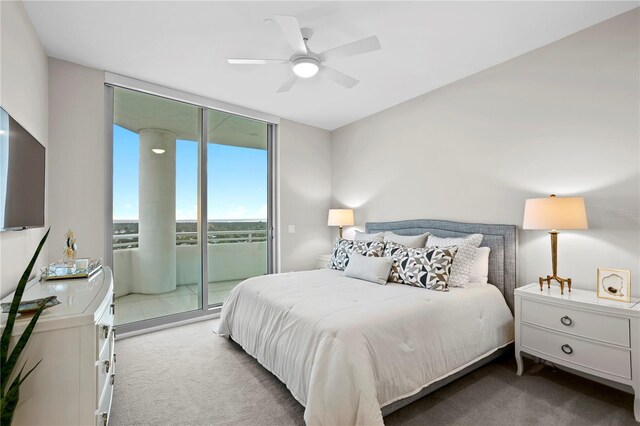 bedroom with light carpet, access to outside, ceiling fan, and floor to ceiling windows