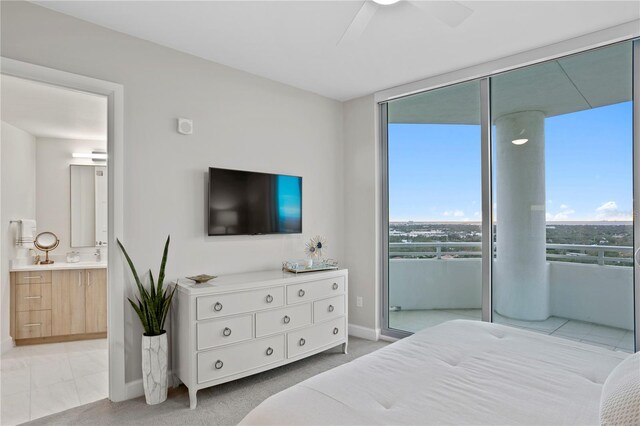 bedroom with access to outside, ensuite bath, and ceiling fan