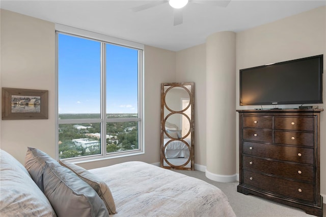 bedroom with ceiling fan and light carpet