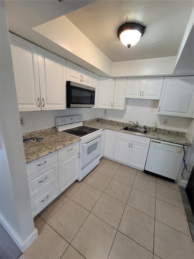 kitchen featuring sink, white cabinets, white appliances, and light tile patterned floors