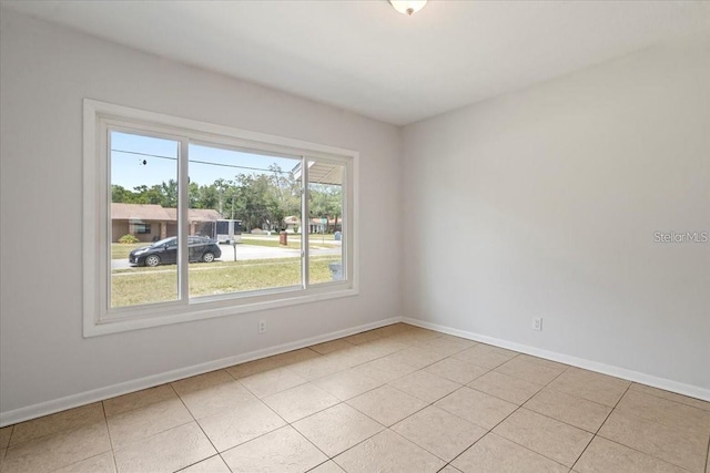 spare room with light tile patterned floors