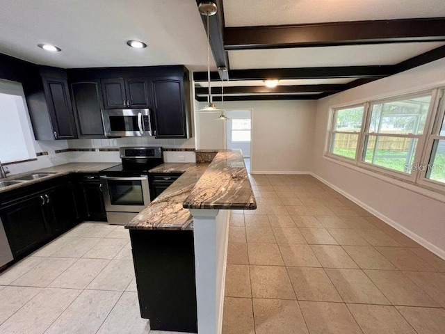 kitchen featuring sink, plenty of natural light, light stone countertops, and appliances with stainless steel finishes