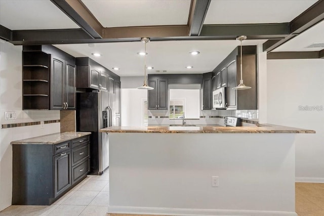 kitchen with beamed ceiling, backsplash, kitchen peninsula, and stainless steel appliances